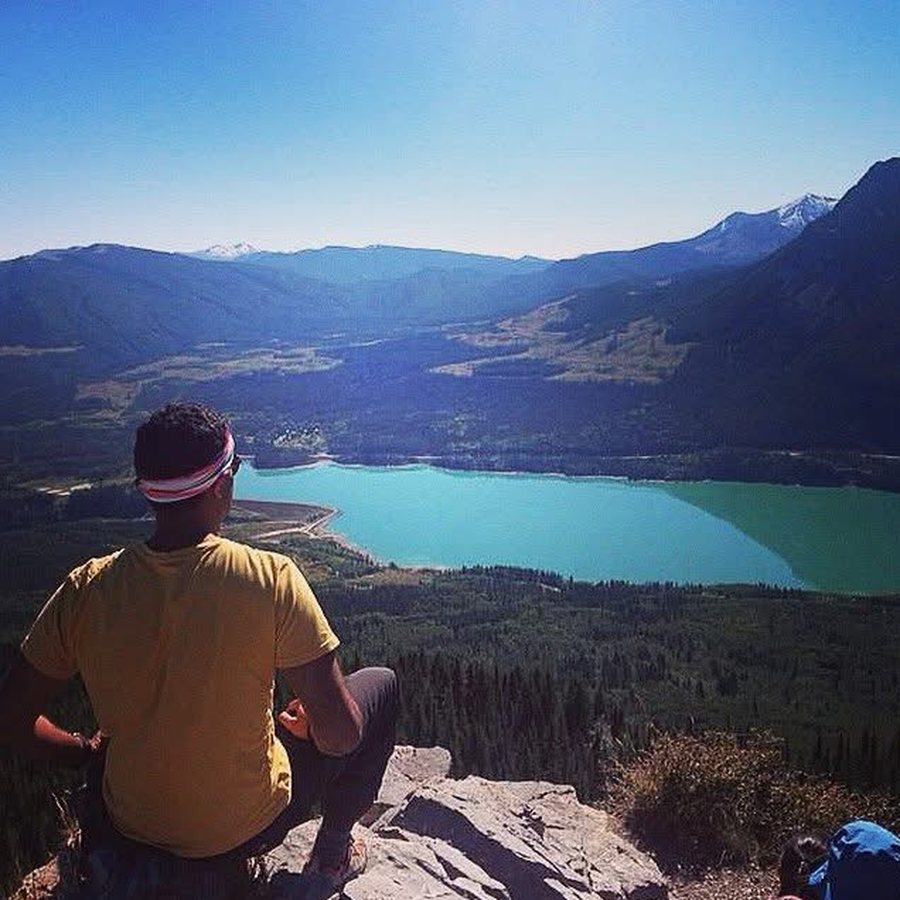 Looking out over a turquoise lake from a rocky outcrop