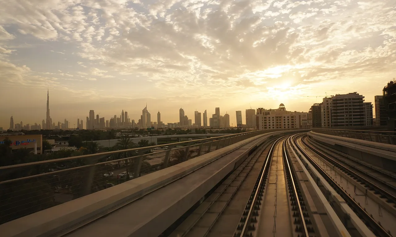 Dubai Metro and skyline at sunset