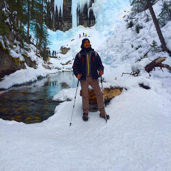 On a frozen canyon trail below an ice fall